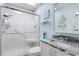 Clean and modern bathroom featuring a glass-enclosed shower, white vanity with a marble countertop, and soft blue walls at 284 Nature Trail, Little River, SC 29566