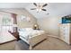 Cozy bedroom with neutral tones, a large bed, vaulted ceilings, and ample natural light at 284 Nature Trail, Little River, SC 29566