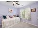Cozy bedroom with a trundle bed, soft purple walls, and sheer floral curtains for a light and airy feel at 284 Nature Trail, Little River, SC 29566