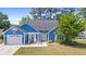 Charming blue single-Gathering home with a lush green lawn, white trim, and a lovely front-yard patio area at 284 Nature Trail, Little River, SC 29566