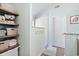 Hallway with storage shelves and a doorway to a bright shower and bathtub area at 284 Nature Trail, Little River, SC 29566