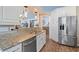 This open concept kitchen features granite countertops, stainless steel appliances, and a breakfast bar at 284 Nature Trail, Little River, SC 29566