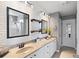 Modern bathroom boasts double sinks, framed mirrors, and stylish lighting fixtures at 3136 Robins Nest Way, Myrtle Beach, SC 29579