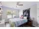 Charming bedroom with window views, accented by a ceiling fan and decorative lighting at 3136 Robins Nest Way, Myrtle Beach, SC 29579