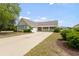 Well-kept one-story house featuring a front porch, attached garage, and a spacious driveway at 3136 Robins Nest Way, Myrtle Beach, SC 29579