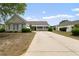One-story home showcasing a well-maintained exterior and an ample driveway for parking at 3136 Robins Nest Way, Myrtle Beach, SC 29579