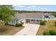 Well-maintained home with a front porch, attached garage, manicured lawn, and a spacious driveway at 3136 Robins Nest Way, Myrtle Beach, SC 29579