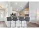 Kitchen with breakfast bar, white cabinets, granite countertops, stainless steel appliances, and four modern bar stools at 3136 Robins Nest Way, Myrtle Beach, SC 29579