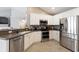 Modern kitchen featuring stainless steel appliances, white cabinets, and an open layout perfect for entertaining at 3136 Robins Nest Way, Myrtle Beach, SC 29579