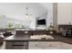 Kitchen sink and counter featuring a breakfast bar, stainless steel dishwasher, and views into the living room at 3136 Robins Nest Way, Myrtle Beach, SC 29579