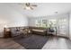 Spacious living room featuring a vaulted ceiling, a brown sectional sofa, and large windows at 3136 Robins Nest Way, Myrtle Beach, SC 29579