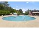Large community pool with lounge chairs, a splash fountain, and a red clubhouse in the background at 3136 Robins Nest Way, Myrtle Beach, SC 29579