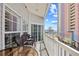 Balcony with patio seating offers views of the building next door and glimpse of ocean at 3401 N Ocean Blvd. # 309, North Myrtle Beach, SC 29582