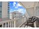 Balcony features chairs and table, offering views of the ocean and building exterior at 3401 N Ocean Blvd. # 309, North Myrtle Beach, SC 29582