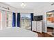 Bedroom with a queen size bed, balcony access, a dresser with TV, and an ensuite bathroom at 3401 N Ocean Blvd. # 309, North Myrtle Beach, SC 29582