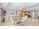 Bright dining area with two tables, seating for eight, and an adjacent kitchen with stainless steel appliances at 3401 N Ocean Blvd. # 309, North Myrtle Beach, SC 29582