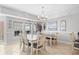 Dining area featuring large table with seating, tile floors, and natural light, perfect for entertaining at 3401 N Ocean Blvd. # 309, North Myrtle Beach, SC 29582