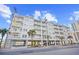 View of condo exterior showing multiple floors of balconies with parking underneath and tropical landscaping at 3401 N Ocean Blvd. # 309, North Myrtle Beach, SC 29582