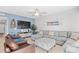 Comfortable living room with a sectional sofa, entertainment center, and coastal decor on a blue accent wall at 3401 N Ocean Blvd. # 309, North Myrtle Beach, SC 29582