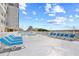 Relaxing pool deck with blue lounge chairs, offering ocean views and clear blue skies at 3401 N Ocean Blvd. # 309, North Myrtle Beach, SC 29582