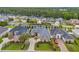 Aerial view of beautiful homes showcasing their manicured lawns, brick exteriors, and lush landscaping at 372 Waterfall Circle, Little River, SC 29566