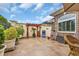 Lovely backyard patio with mature landscaping, an outdoor pergola and wicker seating arrangement at 372 Waterfall Circle, Little River, SC 29566