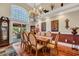 Bright dining room featuring a grand chandelier and sliding glass doors to an outdoor patio at 372 Waterfall Circle, Little River, SC 29566