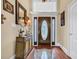 Inviting foyer with hardwood floors, decorative console table, and front door with sidelights at 372 Waterfall Circle, Little River, SC 29566