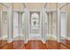 Hallway features mirrored doors, hardwood floors and an arched entrance at 372 Waterfall Circle, Little River, SC 29566