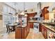 Gourmet kitchen featuring custom cabinets, granite counters, stainless steel appliances, and a breakfast nook at 372 Waterfall Circle, Little River, SC 29566