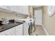 Bright laundry room with white cabinets and modern appliances at 372 Waterfall Circle, Little River, SC 29566