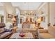 Open-concept living area with hardwood floors, a decorative fireplace, and large windows for natural light at 372 Waterfall Circle, Little River, SC 29566