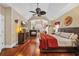 Comfortable main bedroom features a fireplace, ceiling fan and hardwood floors at 372 Waterfall Circle, Little River, SC 29566
