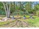 Backyard garden with birdhouses, decorative plants and trees, and green lawn at 3802 Seedling Ct., North Myrtle Beach, SC 29582