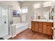 Bathroom featuring a soaking tub, glass enclosed shower and a double sink vanity at 3802 Seedling Ct., North Myrtle Beach, SC 29582