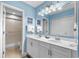 Bright bathroom featuring double sinks, a large mirror, and a walk-in shower at 400 Melrose Pl. # 14E, Myrtle Beach, SC 29572