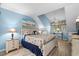 Bright bedroom with a ceiling fan, beach themed décor and beach view art at 400 Melrose Pl. # 14E, Myrtle Beach, SC 29572