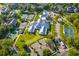 Aerial view of community center, tennis courts, and a putting green, surrounded by lush greenery at 400 Melrose Pl. # 14E, Myrtle Beach, SC 29572
