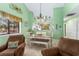 Dining area with seating and bright green walls, offering a relaxing dining experience with a coastal theme at 400 Melrose Pl. # 14E, Myrtle Beach, SC 29572