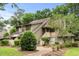 Two-story condo features beautiful landscaping, stairs to the front door, and neutral toned siding at 400 Melrose Pl. # 14E, Myrtle Beach, SC 29572