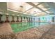 Bright indoor swimming pool featuring a splash zone and ample seating, perfect for year-round enjoyment at 400 Melrose Pl. # 14E, Myrtle Beach, SC 29572