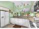 Well-lit kitchen with white cabinets, granite countertops, and modern appliances at 400 Melrose Pl. # 14E, Myrtle Beach, SC 29572
