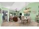 Open-concept living and dining area featuring comfortable furniture, a fireplace, and a serene green color scheme at 400 Melrose Pl. # 14E, Myrtle Beach, SC 29572