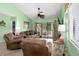 Spacious living room features comfortable seating, bright green walls, and views of the outdoor deck at 400 Melrose Pl. # 14E, Myrtle Beach, SC 29572
