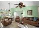 Cozy living room with brown furniture, a wicker ceiling fan, and coastal decor creating a relaxing atmosphere at 400 Melrose Pl. # 14E, Myrtle Beach, SC 29572