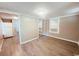 Bedroom with light walls, hardwood floors, mirror closet, and a refrigerator at 401 Alder St., Myrtle Beach, SC 29577