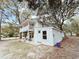 Charming home with a white exterior, balcony, and mature trees at 401 Alder St., Myrtle Beach, SC 29577