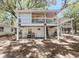 Two-story home featuring double porches, white railings, and a welcoming entrance at 401 Alder St., Myrtle Beach, SC 29577
