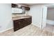 Kitchen with dark cabinets, stainless steel sink and wood floors at 401 Alder St., Myrtle Beach, SC 29577