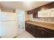 Kitchen with white appliances, and dark wood cabinets at 401 Alder St., Myrtle Beach, SC 29577
